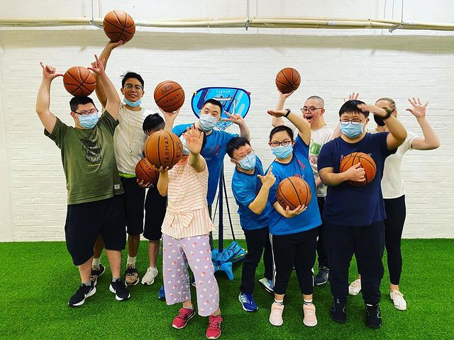 A group of people wearing face masks posing for a photo.